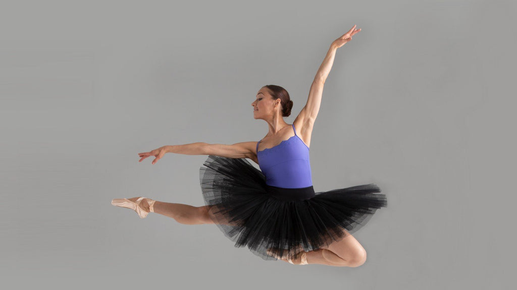 A ballet dancer leaping during performance day
